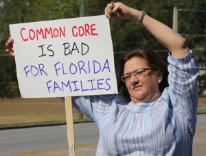 P.G. Schafer, a Tea Party member, holds a sign to protest Common Core across the street from Marion Technical Institute where school administrators were meeting on Southeast Fort King Street in Ocala, Fla. on Wednesday, April 3, 2013.