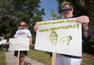 Tea Party members, Lois Miller, right, and Charlie Batchelder, left, hold signs to protest Common Core across the street from Marion Technical Institute where school administrators were meeting on Southeast Fort King Street in Ocala, Fla. on Wednesday, April 3, 2013. 