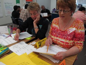 Joanne Land, right, sorts vocabulary words into tiers to learn more about how Common Core standards work. Land was one of hundreds of parents who attended a recent Parent University session. Many parents said they wanted to learn more about Common Core standards and testing.