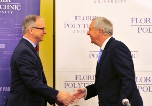 Randy Avent, left, shakes hands with Florida Polytechnic Board of Trustees Chair Rob Gidel.