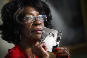 Mamie Pinder, holds a photograph of herself as a young teaching student. Pinder, a retired Miami-Dade school teacher, began teaching in 1963, the year the school district began merging black and white students bodies and faculty.