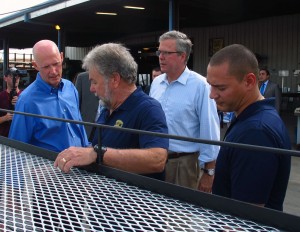 Gov. Rick Scott and former Gov. Jeb Bush tour a Homestead manufacturing facility in August.