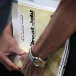 A job seeker clutches a training program catalog at job fair in Illinois this month.