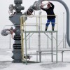 An employee controls a valve at a natural gas storing facility.
