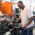 Inmate running a lathe