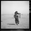 A farmer's son in 1936, standing amid the Dust Bowl landscape of Cimarron County in Oklahoma's panhandle.