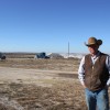 Jarod Pachner A parade of trucks pass by Jarod Pachner as he stands in the front yard of his Ellis County home, which is surrounded by oil and gas wells.