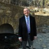 Duane Smith, water consultant for the Chickasaw Tribe, in front of Hillside Spring at the Chickasaw National Recreation Area in Sulphur, Okla.
