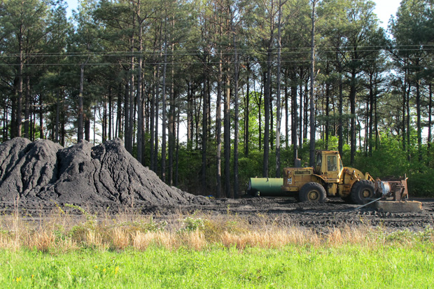 A pile of coal sits along the railroad tracks just east of Red Oak, Okla.