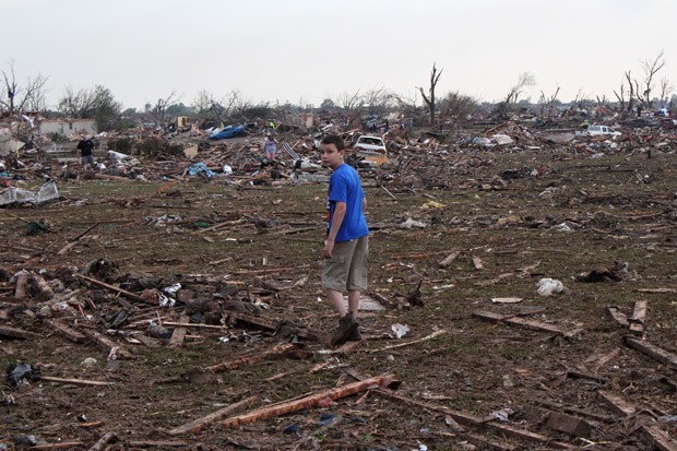 Eleven-year-old Gavin Hawkins stand near the rubble of the Plaza Tower Elementary School. His dad, Joel, rushed to the school to pick up his son before the storm hit.