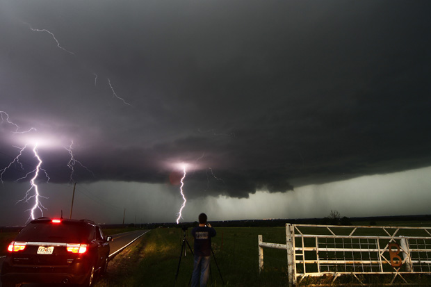 Cloud to ground lightning strikes near storm chasers during a tornado thunderstorm in Cushing, Okla., on May 31. 