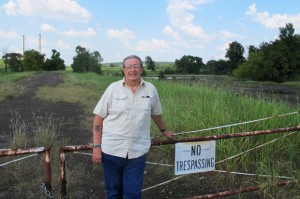 Grand Riverkeeper Earl Hatley stands at the edge of the GRDA power plant's property near Chouteau, Okla. 