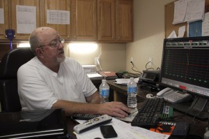 John Boyd, a petroleum engineer, looks at well readings inside a control room at a Triad Energy horizontal drilling operation.
