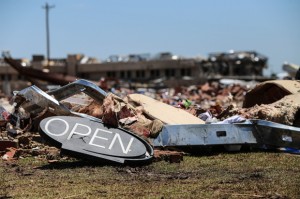 An 'open' sign is one of the few items left after a tornado struck this convenient store in Moore, Okla.