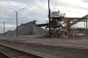 A pile of crushed limestone sits near the train tracks at Texas Industry's large mining operation near Mill Creek, Okla. 