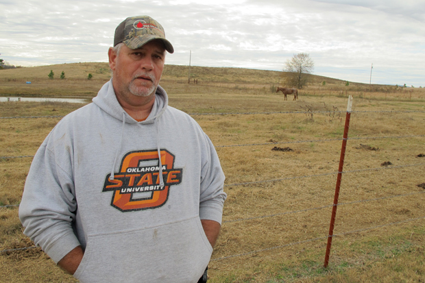 Leflore County resident Alan Brady says the large berm in the background blocks the view of the mountains he had before mining started. 