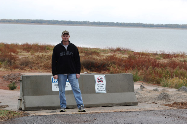 Jeff Converse of the Canton Lake Association stands in front of a boat ramp he says has been surrounded by mud and weeds since Oklahoma City withdrew water from the lake in January.