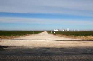 A water line for hydraulic fracturing traverses an oil and gas access road in Woods County.
