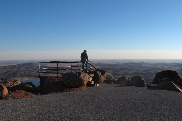 Meers area resident Bill Cunningham looks for haze over the Wichita Mountains from the top of Mt. Scott.