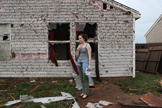 Lauren Gardner stands near a family members house, which was destroyed by the tornado.