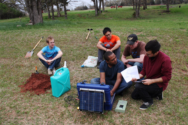 University of Oklahoma graduate students near Wellston, Okla., installing a seismometer to study central-Oklahoma's earthquake swarm