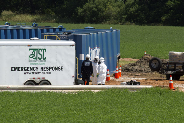 Crews work to contain and clean up 20,000 gallons of hydrochloric acid that spilled near a hydraulic fracturing site near Hennessey, Okla.