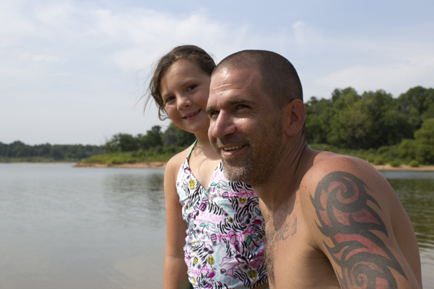Shaun Pelkey and his daughter Ireland Pelkey enjoy the afternoon at one of Walnut Creek State Park's beaches on Keystone Lake. 