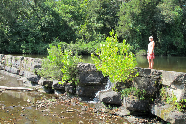 Debbie Doss, conservationist for the Arkansas Canoe Club, stands on Natural Dam a few hundred feet upstream from Lee Creek in northwest Arkansas. 