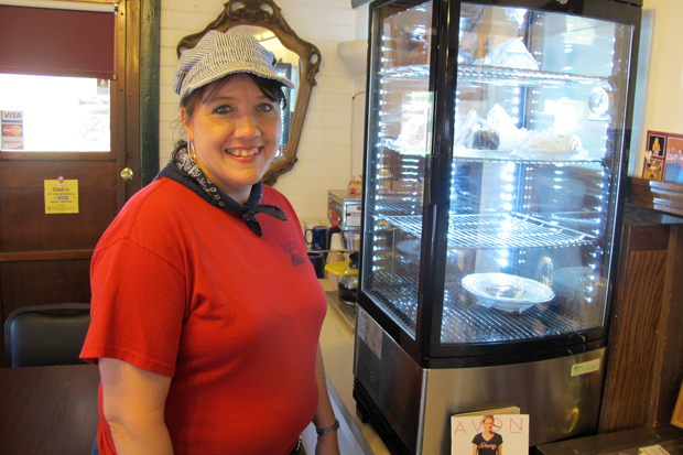Waitress Leslea Abshire stands next to a case of pies at the Southern Belle Cafe in Heavener, Okla., in May 2013. 