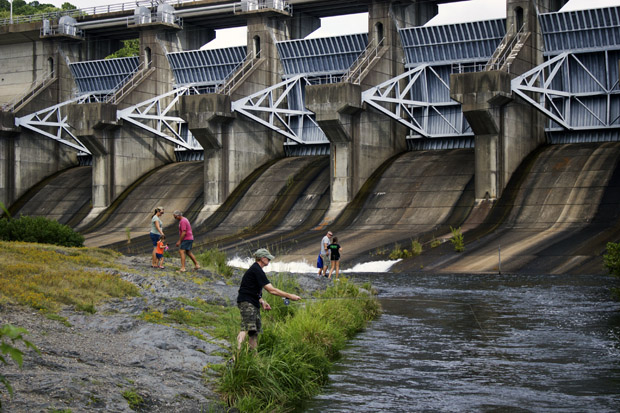 Families and a fisherman along the spillway beneath Broken Bow Dam in southeastern Oklahoma.