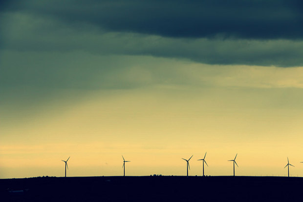 A line of wind turbines dot a stormy horizon in Oklahoma.