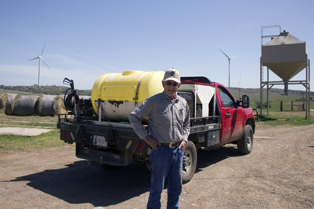 Bob Kerr on his ranch near Carnegie, Okla., which is flanked by turbines from the Blue Canyon Wind Farm.