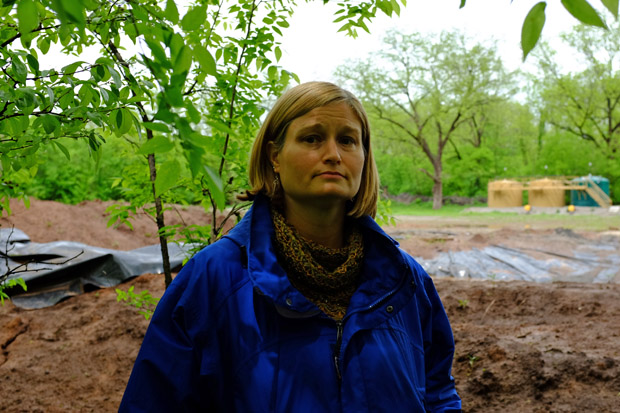 Stillwater resident Tammy Mix stands in front of an oil and gas well behind her house.