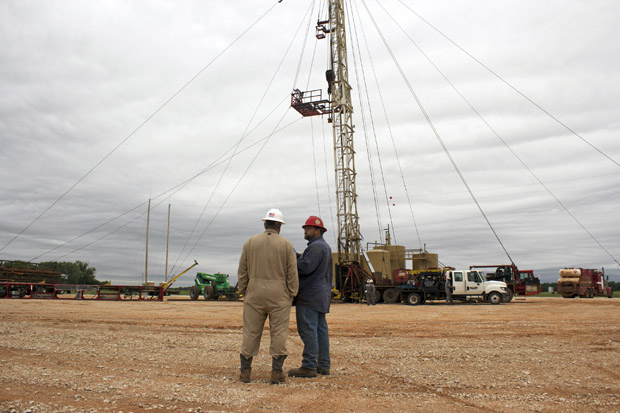 Jay Storm, left, the completions superintendent for Eagle Energy Exploration, and a service company worker oversee the plug-back of the George No. 1 saltwater disposal well.