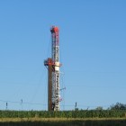 A drill rig rises above a farm in Susquehanna County, Pa.
