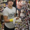 Brandon Bennington helps clean up after Tuesday's earthquake knocked food off supermarket shelves in Mineral, Va.