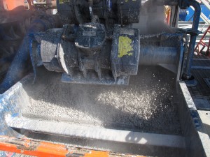 The "cuttings" - rock and dirt from deep underground - are churned up by a drill to be loaded into a dumpster at a well site in Susquehanna County, Pa.