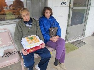 Jeanie Moten with her sister on their mother's porch in Rea, Pa. She holds a stack of medical records. The Motens say they received no help from DOH regarding their fracking health complaints. A case file released by the DOH through a Right-To-Know request confirmed that.
