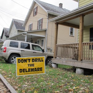 A drilling protest sign sits on the lawn of a home along the Delaware River.