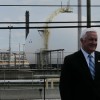 Gov. Tom Corbett stands in front of the shuttered Sunoco refinery in Marcus Hook, Delaware County.
