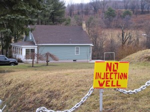 A sign protesting a proposed deep injection well sits on the lawn of a home in Brady Township, Clearfield County.