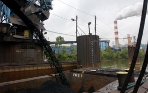 As coal is poured into a waiting barge, smoke billows from a coal powered electric plant August 26, 2001 in western, PA. 