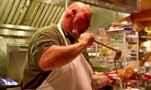 Summerhouse Grill chef pours a porter bÃ©chamel sauce over the pork sausage strudel.