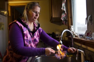Sherry Vargson, who leased the mineral rights under a portion of her farm to the gas company Chesapeake Energy, illustrates her assertion that methane has leached into her well water by lighting the water on fire as it pours from her kitchen sink in Granville Summit.