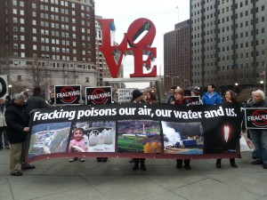 Anti-fracking activists protest gas drilling at Philadelphia's Love Park.