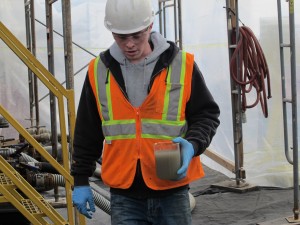 A worker collects a water sample at a natural gas wastewater recycling plant in Susquehanna County.
