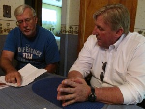 Terry Van Curen (left) shows his royalty statements to Bradford County Commissioner Doug McLinko. 