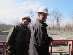 Cabot Oil and Gas public relations officer George Stark with a drill rig worker outside of the "dog house."