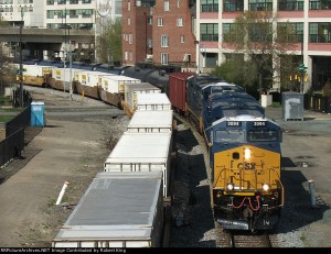 The CSX K040, an oil train bound for South Philadelphia, chugs past an intermodal train through Center City.