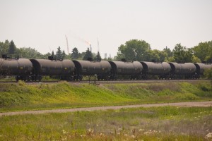 A train pulling a row of tank cars moves along the tracks near a Hess transfer facility near Tioga, North Dakota, U.S., on Thursday, July 11, 2013. There is a continued boom situation in the area due to the ability to extract oil from the Bakken Formation. 